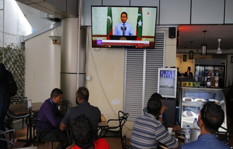 Maldivian watch a live telecast of statement delivered by President Yameen Abdul Gayoom at a cafe in Male, Sept. 24, 2018.