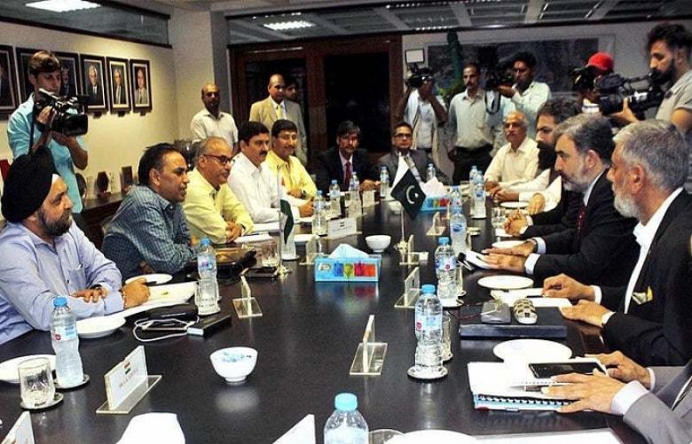 Pakistan’s Commissioner for Indus Waters Syed Muhammad Mehar Ali Shah and members of his team talk to Indian Indus Water Commissioner Pradeep Kumar Saxena and other members of his delegation during a meeting in Lahore in August.