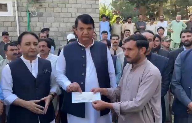 Amir Muqam distributes compensation cheques to flood victims’ families in Ghizer