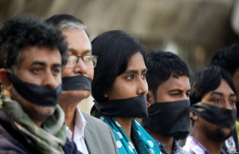  Activists of the leftist alliance cover their mouths with black cloths as they join in a rally to demand a new election under caretaker government, in Dhaka, Bangladesh, Jan. 3, 2019.