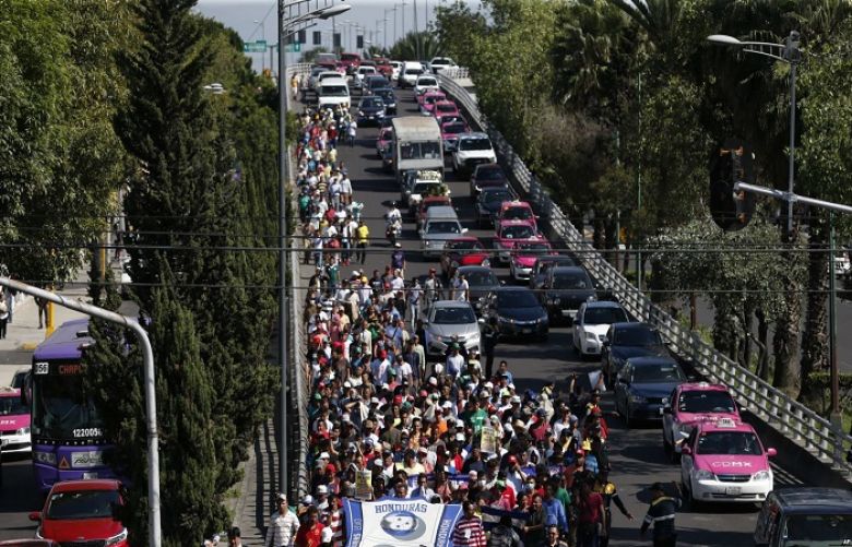U.S.-bound Central American migrants march to the office of the U.N. human rights body in Mexico City, Nov. 8, 2018.