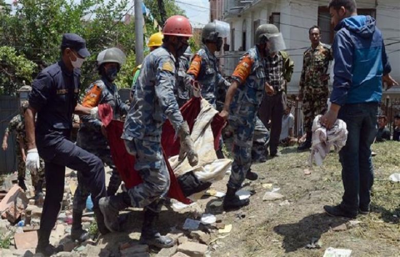 Nepalese police retrieve the body of an earthquake victim during rescue efforts in the Balaju district of the capital, Kathmandu, April 27, 2015.