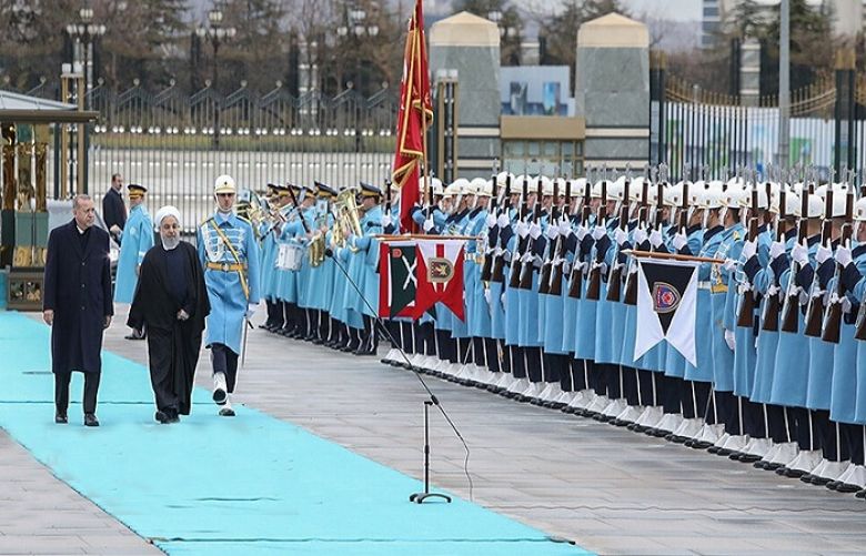 Turkey&#039;s President Recep Tayyip Erdogan (R) shakes hand with Iran&#039;s President Hassan Rouhani (L) review a guard of honour during an official welcoming ceremony ahead of their meeting at the Turkish presidential complex in Ankara on December 20, 2018.