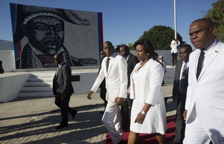 Haiti&#039;s President Jovenel Moise, center, and first lady Martine Moise walk with Prime Minister Jean Henry Ceant as they leave a ceremony marking the 212th anniversary of the assassination of independence hero Gen. Jean-Jacques Dessalines, in Port-au-Prince, Haiti, Oct. 17, 2018.