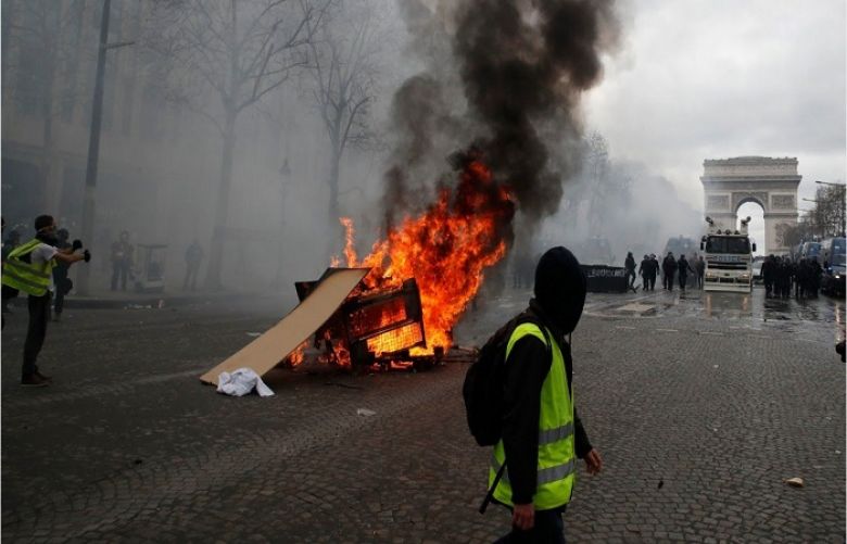 Rioters set fire to a bank and ransacked stores on Paris’s Champs Elysees avenue on Saturday