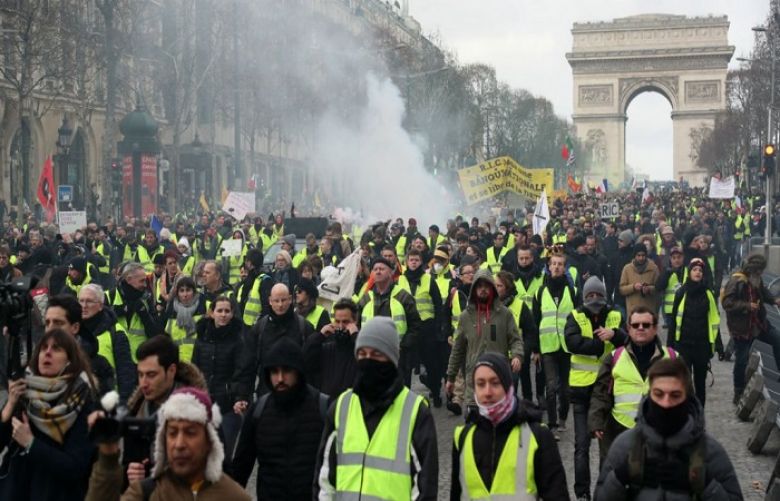 Yellow Vest protesters march during a demonstration near the Arc de Triomphe in Paris on February 9, 2019.
