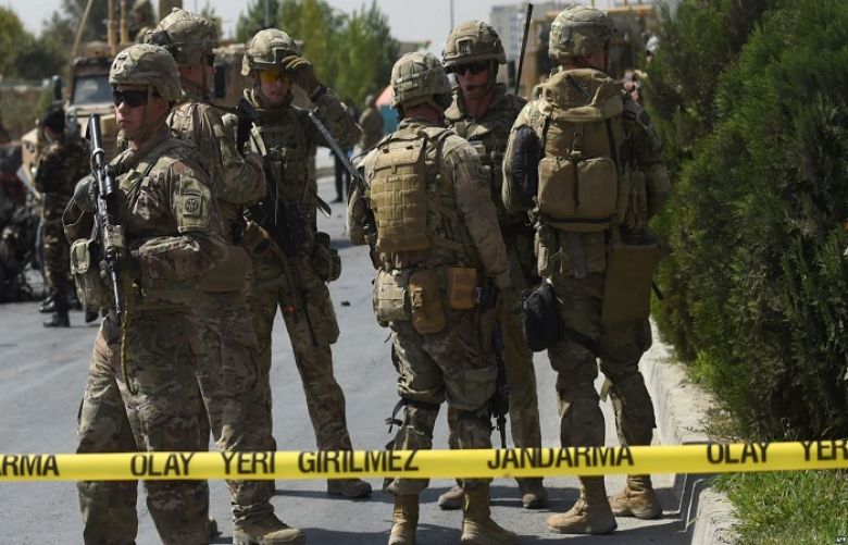 U.S. soldiers and Afghan security personnel investigate at the site of an attack in Kabul, Afghanistan, Sept. 24, 2017.