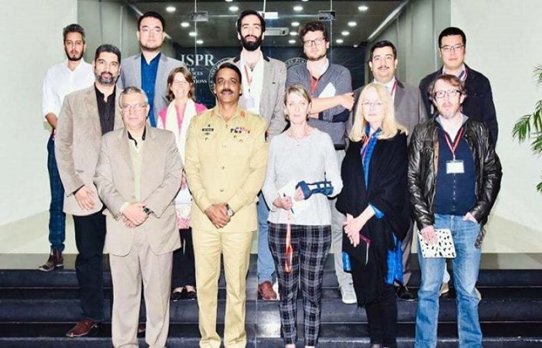 Maj Gen Asif Ghafoor with foreign media representatives outside the ISPR office. 