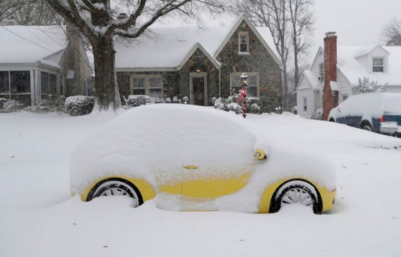 A snow-covered car is parked outside a home in Greensboro, N.C., Sunday, Dec. 9, 2018. A massive storm brought snow, sleet, and freezing rain across a wide swath of the South on Sunday - causing dangerously icy roads, immobilizing snowfalls and power losses. 