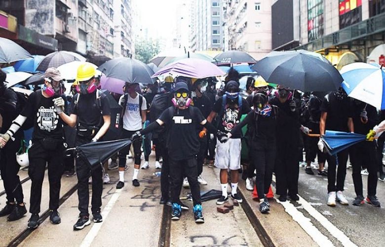  Hong Kong lashed by fresh violence as thousands defy mask ban