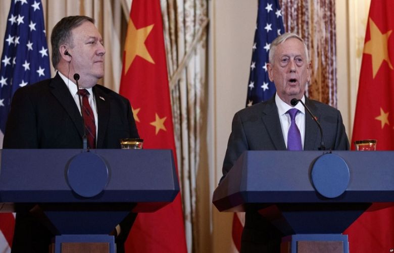 Secretary of State Mike Pompeo looks to Secretary of Defense Jim Mattis during a news conference with Chinese officials at the State Department in Washington, Nov. 9, 2018.