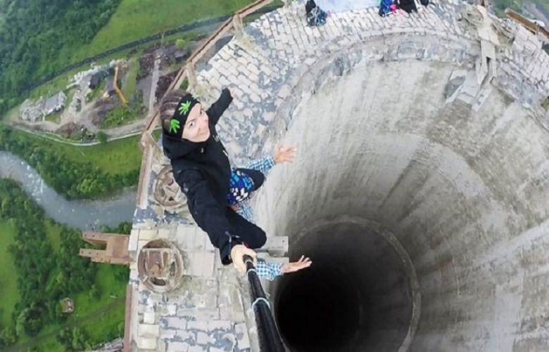 This selfie-taker risked her life on someone&#039;s shoulders at the top of a 180 metre high disused chimney in Romania