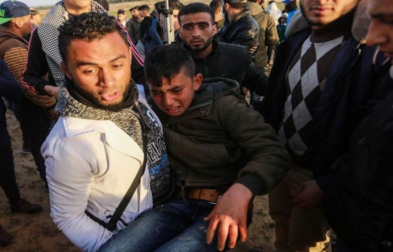 An injured Palestinian carried away during border protest 