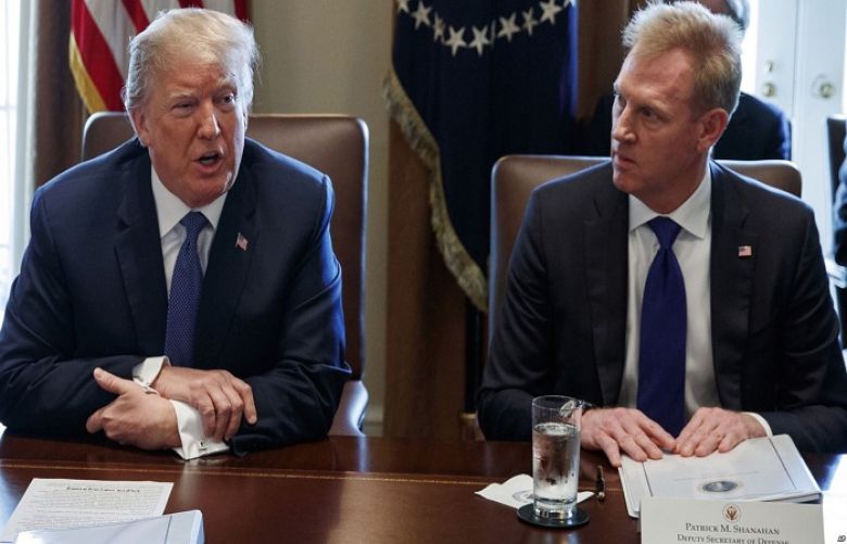 In this April 9, 2018 photo, Deputy Secretary of Defense Patrick Shanahan, right, listen as President Donald Trump speaks during a cabinet meeting at the White House, in Washington.
