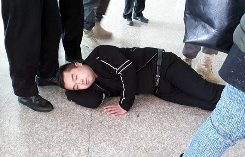 A Chinese passengers lies on the floor in protest against the customs duty at the Islamabad International Airport on Friday.