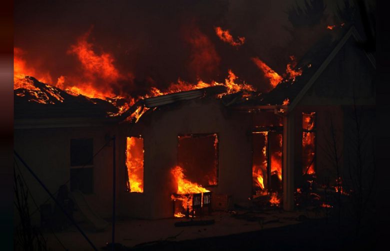 A home is engulfed in flames during the Camp Fire in Paradise, California, U.S. November 8, 2018. 