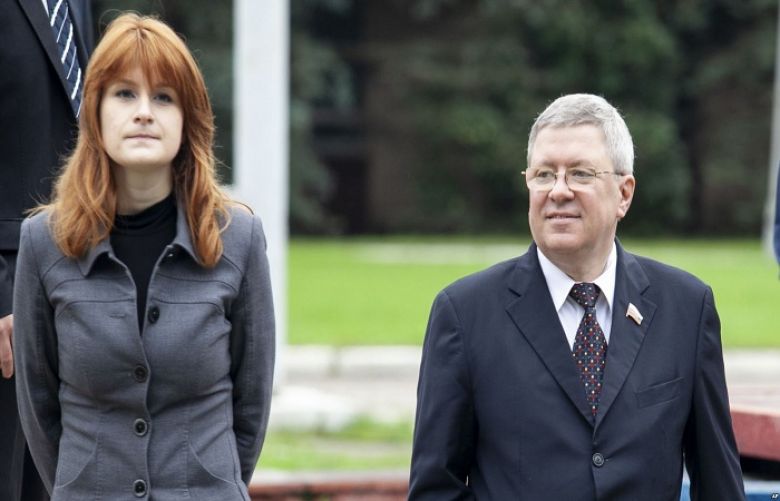 Maria Butina walks with Alexander Torshin then a member of the Russian upper house of parliament in Moscow, Russia, Sept. 7, 2012.