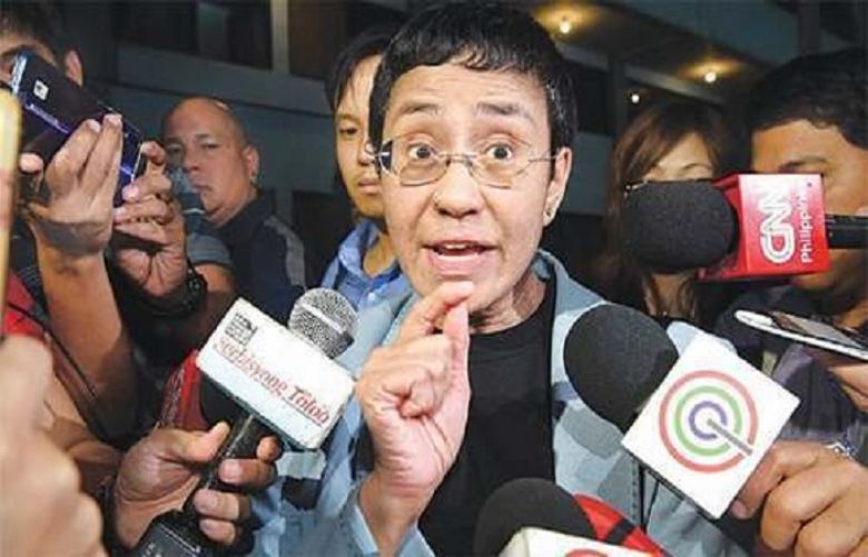 Maria Ressa speaks to the media at the National Bureau of Investigation after her arrest on Wednesday.