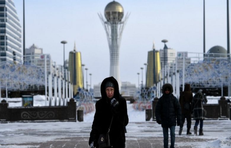 Kirill Kudryavtsev, AFP | In this file photo taken on January 22, 2017 people walk in downtown Astana (now renamed Nursultan), with the Baiterek monument seen in the background.