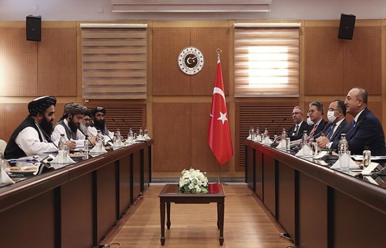  Turkish Foreign Minister Mevlut Cavusoglu and Amir Khan Muttaqi, the acting foreign minister of Afghanistan, speak during a meeting