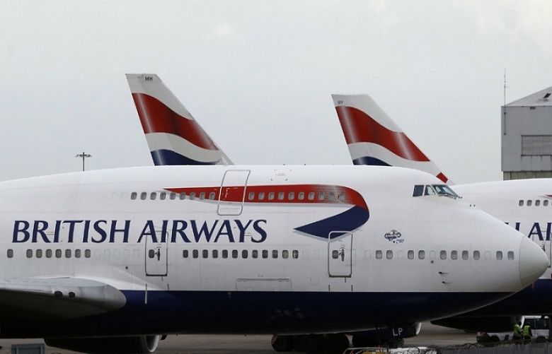 British Airways planes are parked at Heathrow Airport in London. ﻿