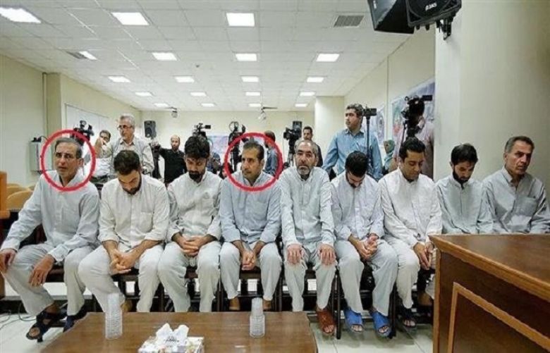 This photo by Mizan news agency shows Vahid Mazlumin (L) and Mohammad Ismail Qasemi pinpointed with circles during a court hearing.