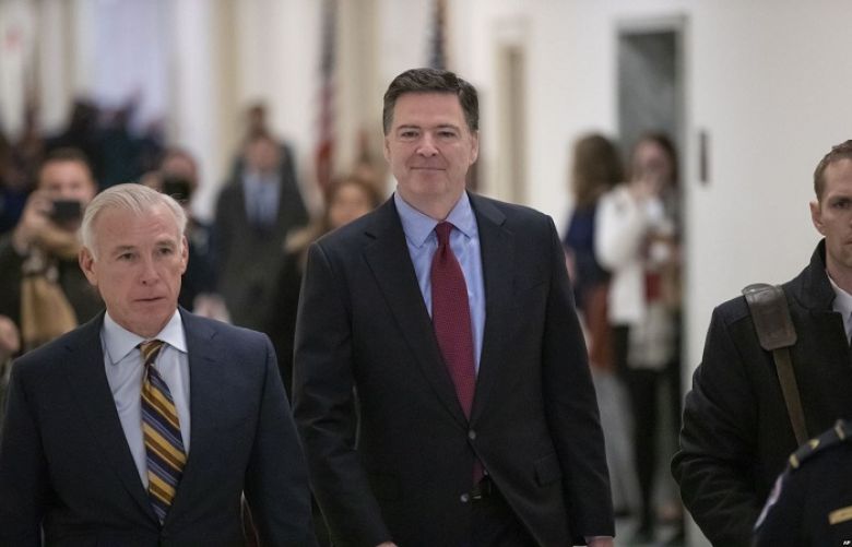 Former FBI Director James Comey, with his attorney, David Kelley, left, arrive to testify under subpoena behind closed doors before the House Judiciary and Oversight Committee on Capitol Hill in Washington, Dec. 7, 2018.