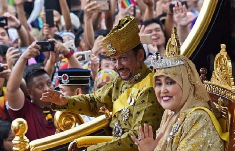 Brunei’s Sultan Hassanal Bolkiah and Queen Saleha ride in a royal chariot during a procession to mark his golden jubilee of accession to the throne in Bandar Seri Begawan on October 5, 2017.