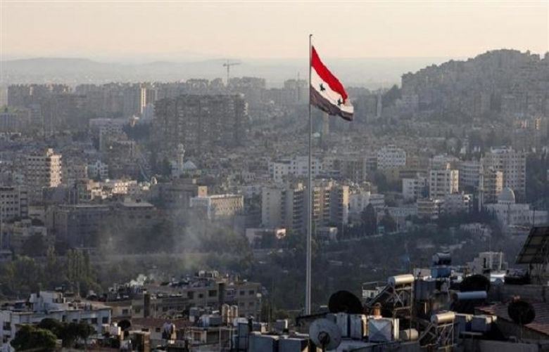 In this file picture, a Syrian flag flutters in central Damascus, Syria. 