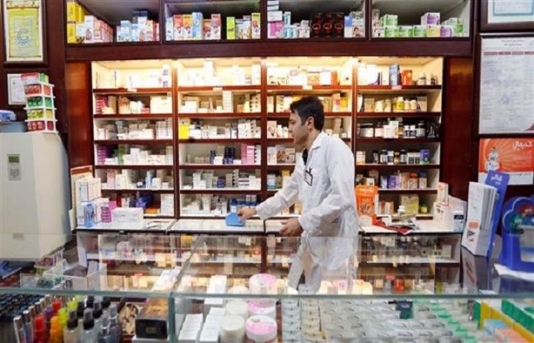 An Iranian man works at a drugstore in Tehran on September 11, 2018. (Photo by AFP)