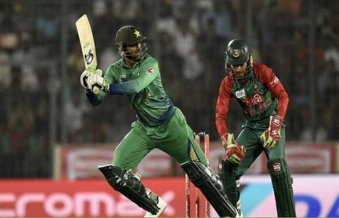Pakistan cricketer Shoaib Malik (L) plays a shot