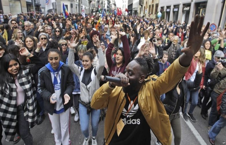 DJ Simon Samaki Osagie, with throngs of protesters behind him, sings during an anti-racism rally, in Milan, Italy, March 2, 2019
