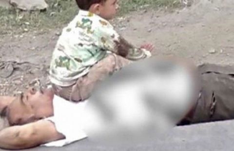 Photo of three-year-old Kashmiri boy sitting over bullet-ridden grandfather's body goes viral