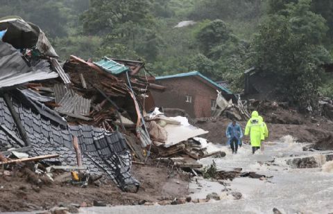 South Korean emergency workers search for survivors after a landslide hit a small village in Yecheon.