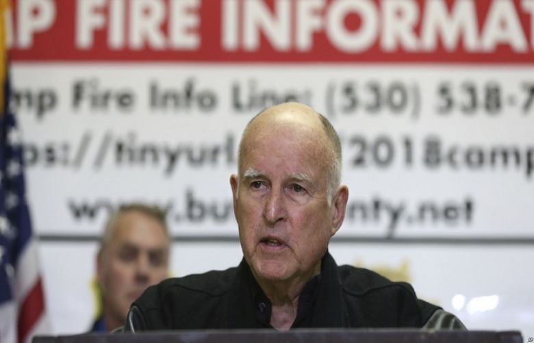 California Gov. Jerry Brown, responds to a reporters question during a news conference held with U.S. Secretary of the Interior Ryan Zinke, left, after touring the fire ravaged town of Paradise, Calif, Nov. 14, 2018.
