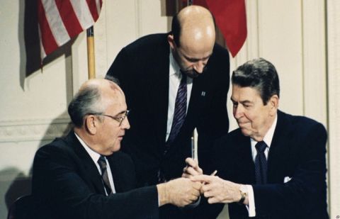U.S. President Ronald Reagan (R) and Soviet leader Mikhail Gorbachev exchange pens during the Intermediate Range Nuclear Forces Treaty signing ceremony in the White House East Room in Washington, D.C., Dec. 8, 1987.