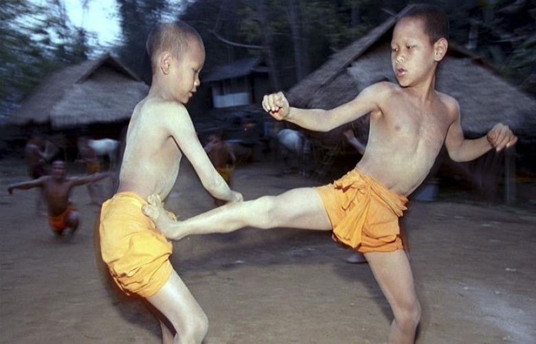 Two novice Buddhist monks practice Muay Thai in northern Thailand