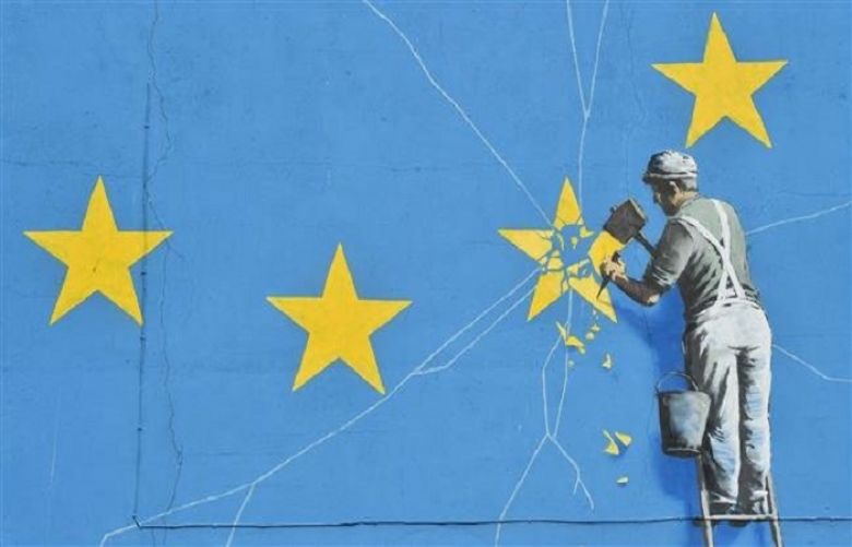 A mural by British artist Banksy, depicting a workman chipping away at one of the stars on a European Union (EU) themed flag, is pictured in Dover, south east England on January 7, 2019. 