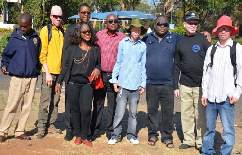 People with albinism pose with campaigners for their rights in the capital of Lilongwe, Malawi, in early 2016 before the start of street protests against attacks.
