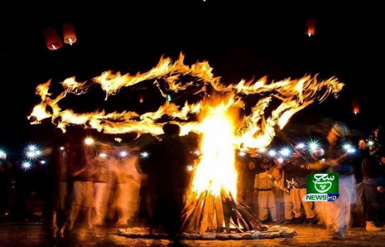People dance around bonfire to celebrate Mayfung ferstival in skardu