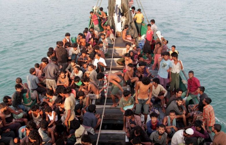 Rohingya refugees sit in a boat bound to Australia.
