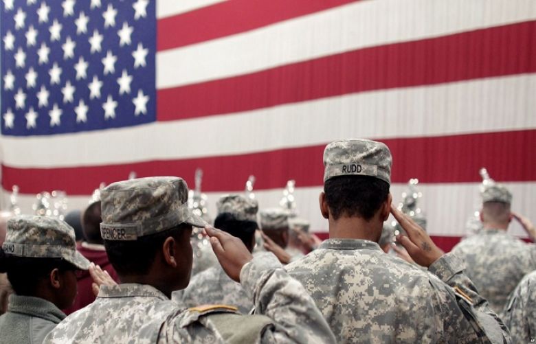 Soldiers salute the U.S. flag during a welcome home ceremony for soldiers at Fort Carson, Colo., Dec. 5, 2012. A Fort Carson soldier has been charged with killing his wife.