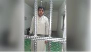 Shahbaz Gill poses for pics from behind the bars