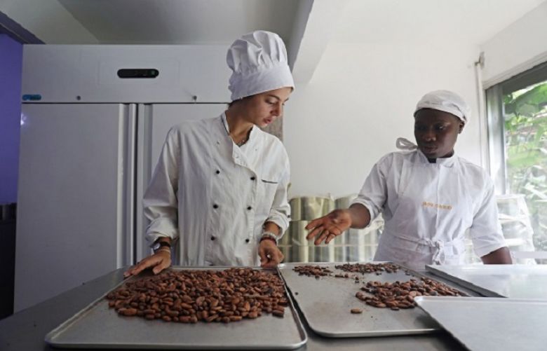 Dana Mroueh, owner of the handmade organic raw chocolate factory “Mon Choco”, prepares to grind cocoa beans with the help of a bicycle in Abidjan, Ivory Coast January 10