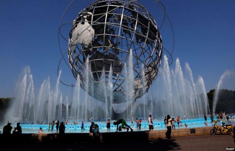 People cool off at the Unisphere in Queens, New York, July 2, 2018. The weather in New York City in a few decades will feel like how Arkansas is now, and Chicago will seem like Kansas City if global warming continues at the current pace, a new study finds.