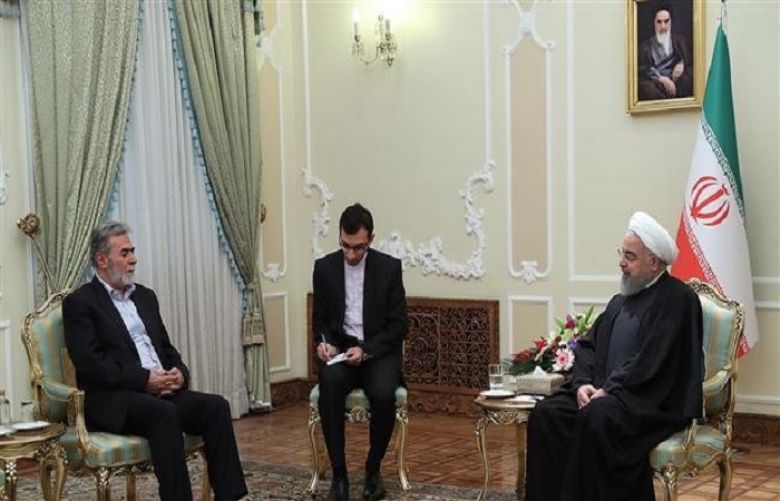 Iranian President Hassan Rouhani (R) meets with visiting Secretary General of the Palestinian Islamic Jihad resistance movement, Ziad al-Nakhala, in Tehran.