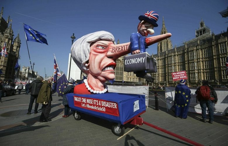 Anti-Brexit demonstrators with an effigy of British Prime Minister Theresa May near College Green at the Houses of Parliament in London, Monday, April 1, 2019. Britain&#039;s Parliament gets another chance Monday to offer a way forward on Britain&#039;s stalled divorce from the European Union, holding a series of votes on Brexit alternatives in an attempt to find the elusive idea that can command a majority. 