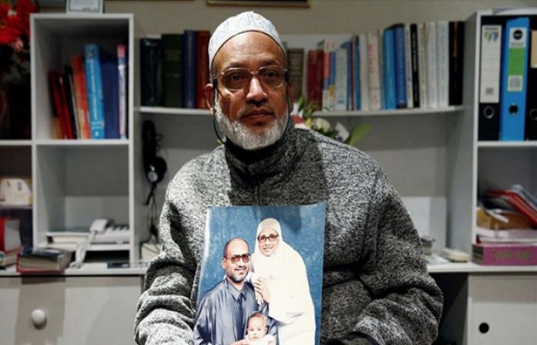 Al Noor mosque shooting survivor Farhid Ahmed poses with a photo of his wife Husna