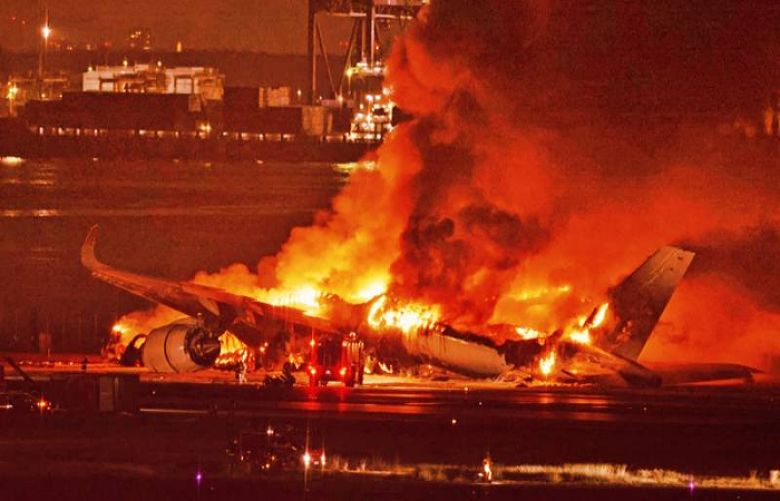 Passengers escape plane engulfed in flames at Japan airport after collision