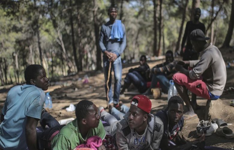 Sub-Saharan migrants aiming to cross to Europe take shelter in a forest overlooking the neighborhood of Masnana, on the outskirts of Tangier, Morocco, Sept. 5, 2018.
